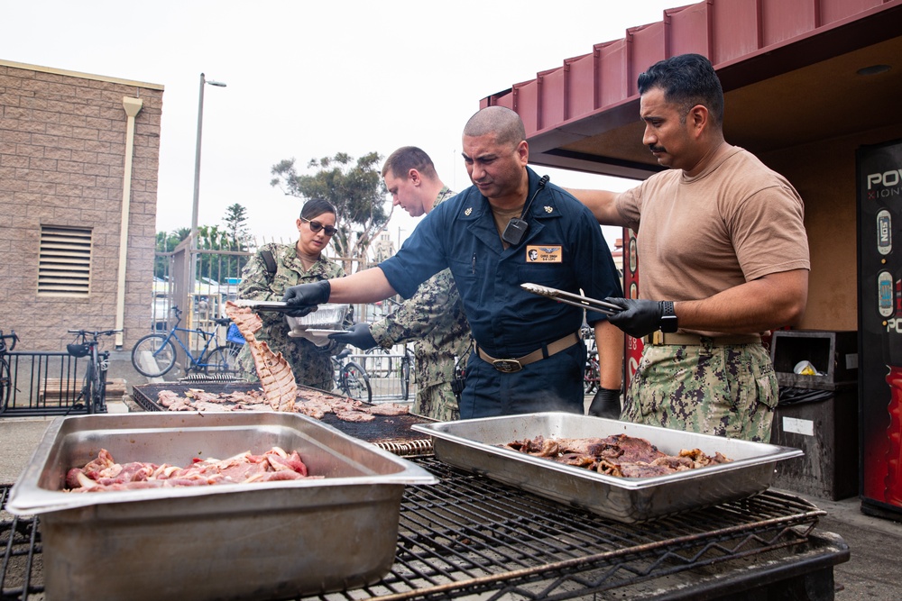 Abraham Lincoln Sailors participate in a fundraising BBQ event