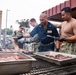 Abraham Lincoln Sailors participate in a fundraising BBQ event