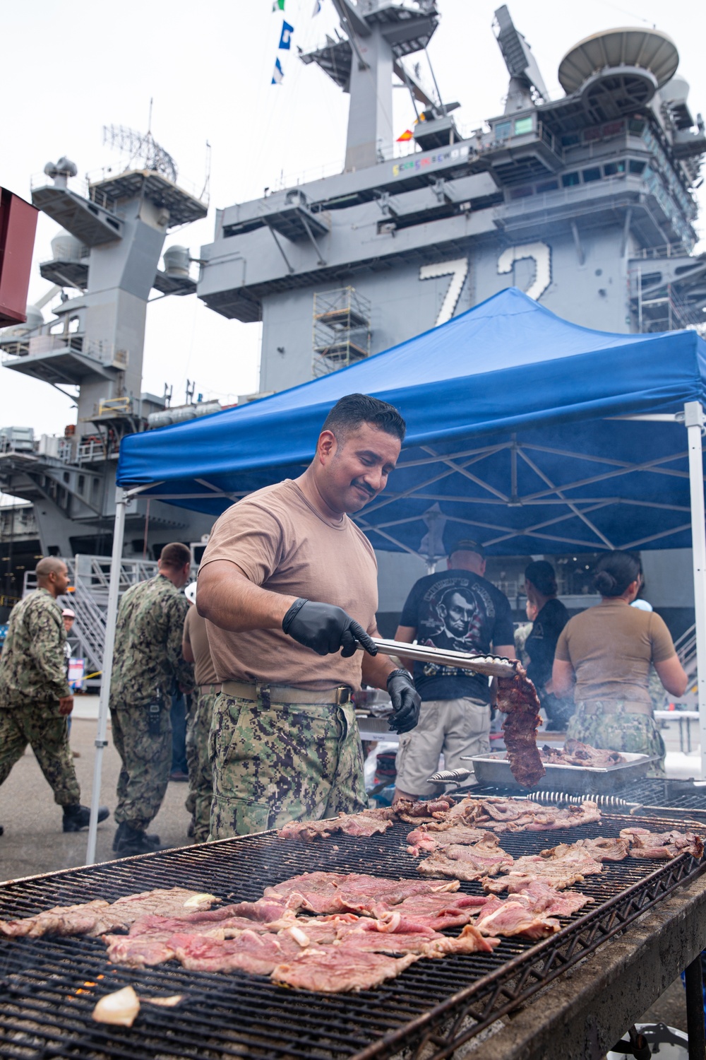 Abraham Lincoln Sailors participate in a fundraising BBQ event