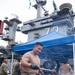 Abraham Lincoln Sailors participate in a fundraising BBQ event