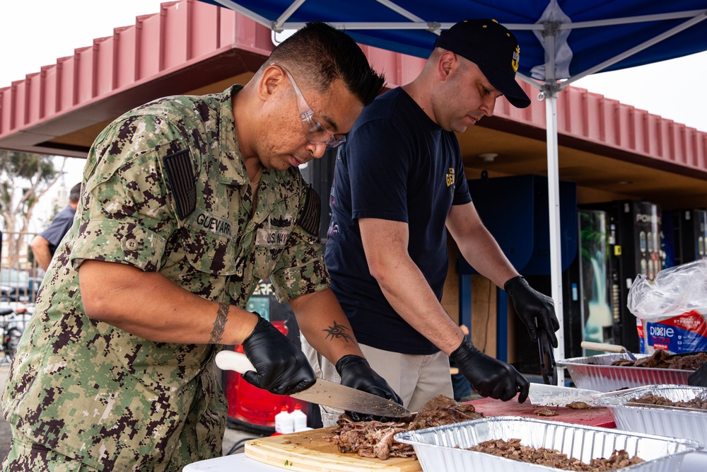 Abraham Lincoln Sailors participate in a fundraising BBQ event