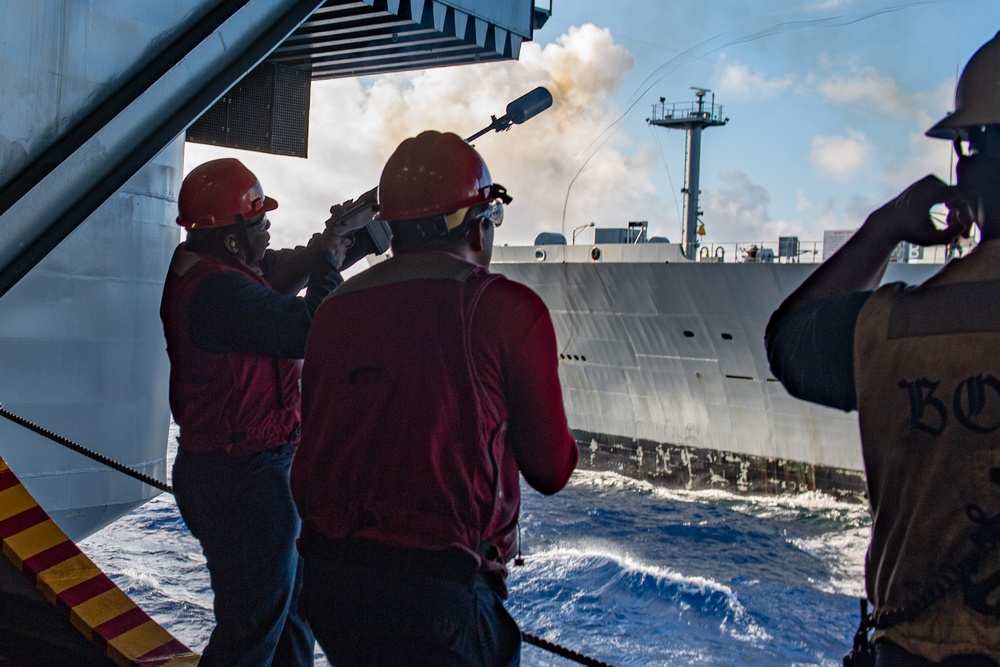 USS Ronald Reagan (CVN 76) conducts replenishment-at-sea with USNS Yukon (T-AO 202) and USNS Carl Brashear (T-AKE 7)