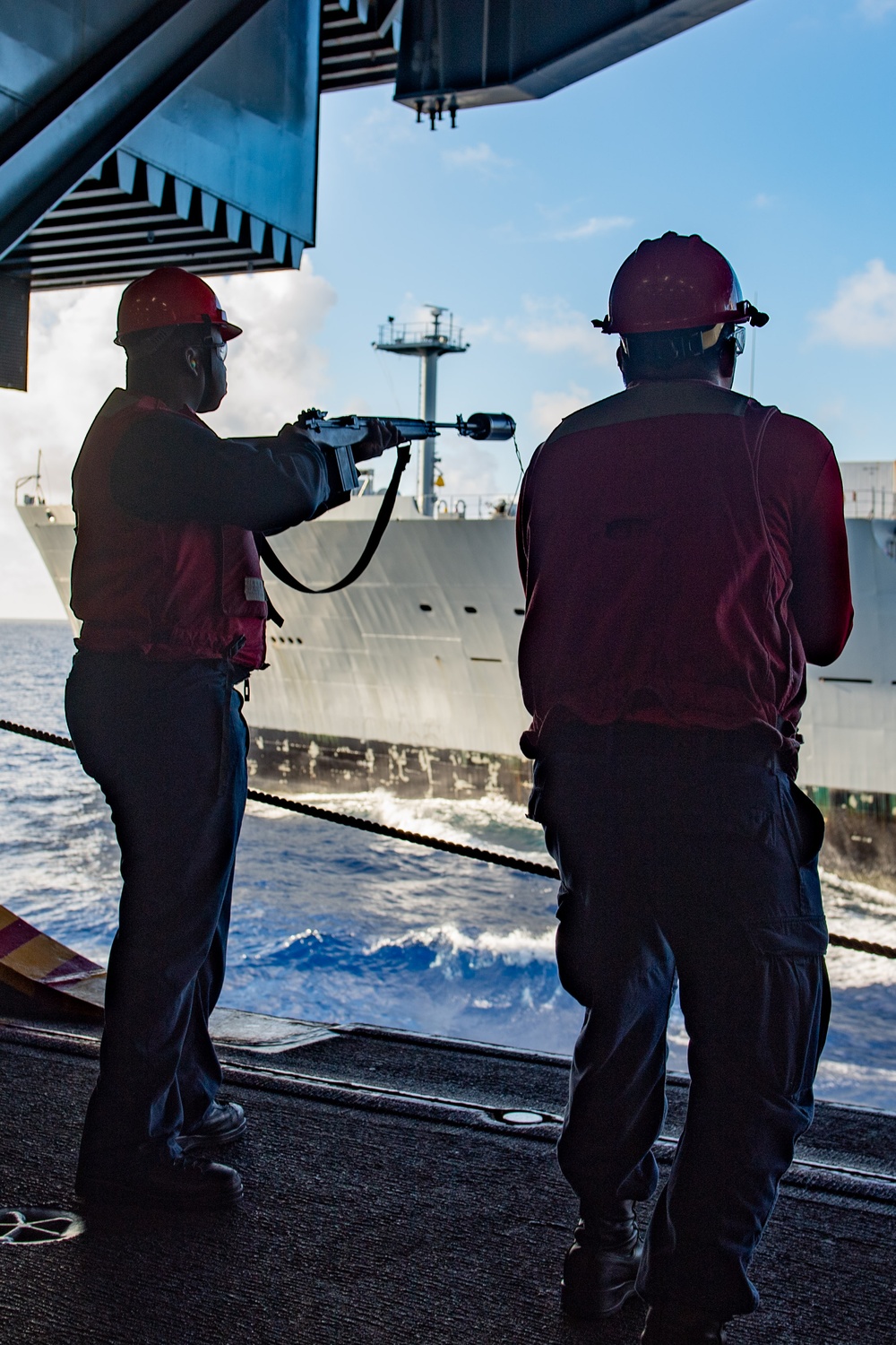 USS Ronald Reagan (CVN 76) conducts replenishment-at-sea with USNS Yukon (T-AO 202) and USNS Carl Brashear (T-AKE 7)