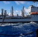 USS Ronald Reagan (CVN 76) conducts replenishment-at-sea with USNS Yukon (T-AO 202) and USNS Carl Brashear (T-AKE 7)