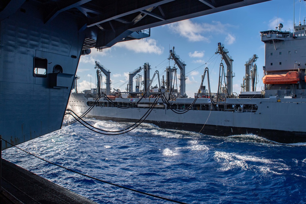 USS Ronald Reagan (CVN 76) conducts replenishment-at-sea with USNS Yukon (T-AO 202) and USNS Carl Brashear (T-AKE 7)