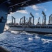 USS Ronald Reagan (CVN 76) conducts replenishment-at-sea with USNS Yukon (T-AO 202) and USNS Carl Brashear (T-AKE 7)