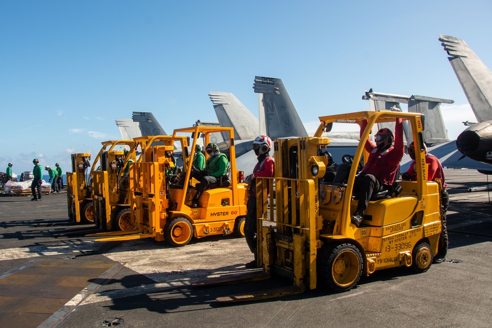 USS Ronald Reagan (CVN 76) conducts replenishment-at-sea with USNS Yukon (T-AO 202) and USNS Carl Brashear (T-AKE 7)