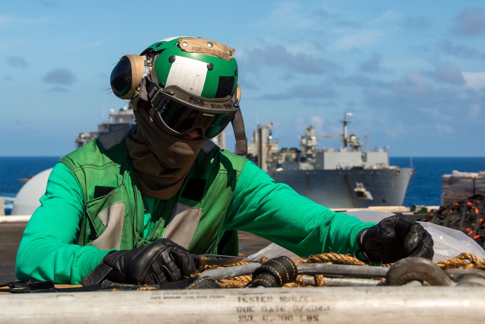 USS Ronald Reagan (CVN 76) conducts replenishment-at-sea with USNS Yukon (T-AO 202) and USNS Carl Brashear (T-AKE 7)