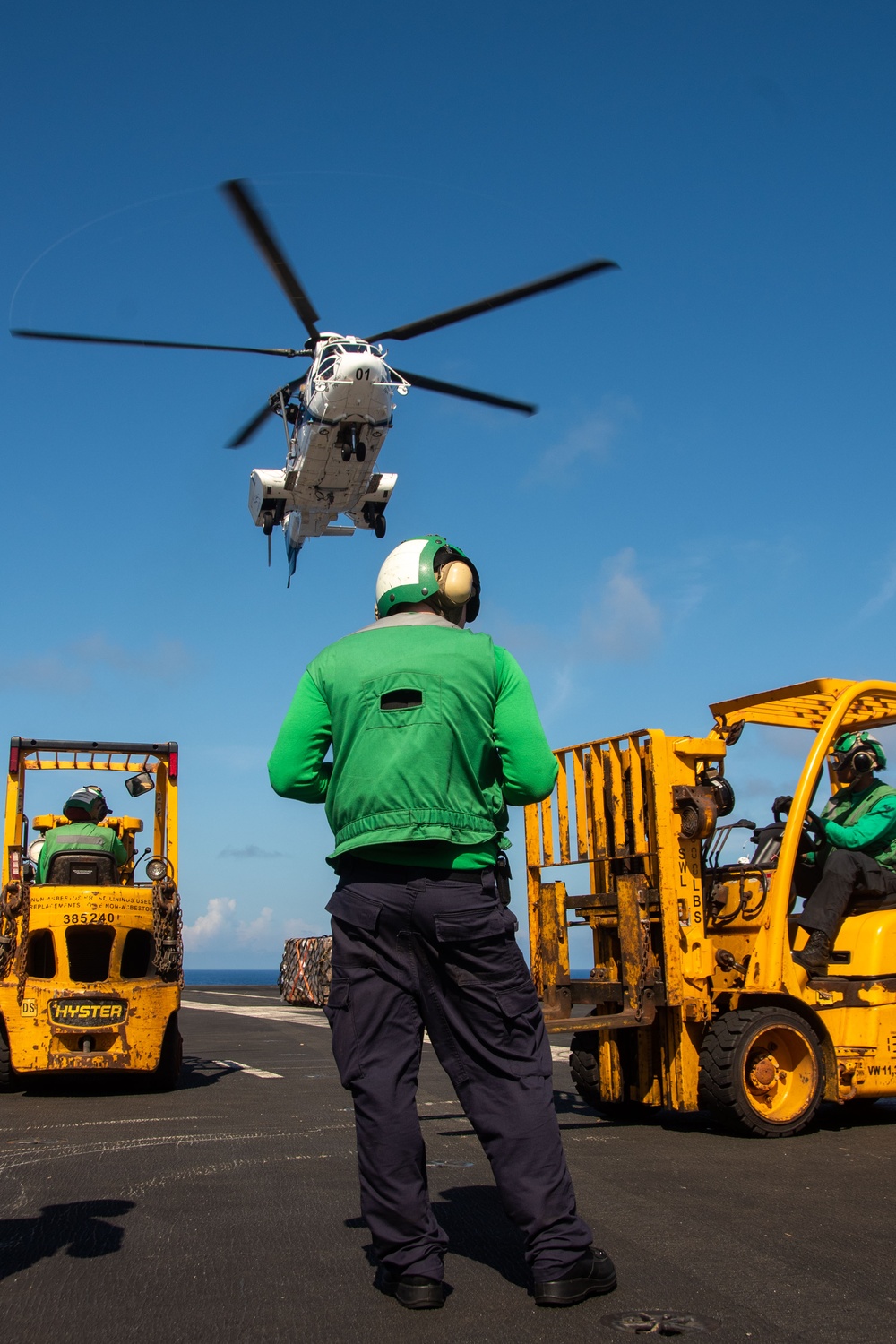 USS Ronald Reagan (CVN 76) conducts replenishment-at-sea with USNS Yukon (T-AO 202) and USNS Carl Brashear (T-AKE 7)