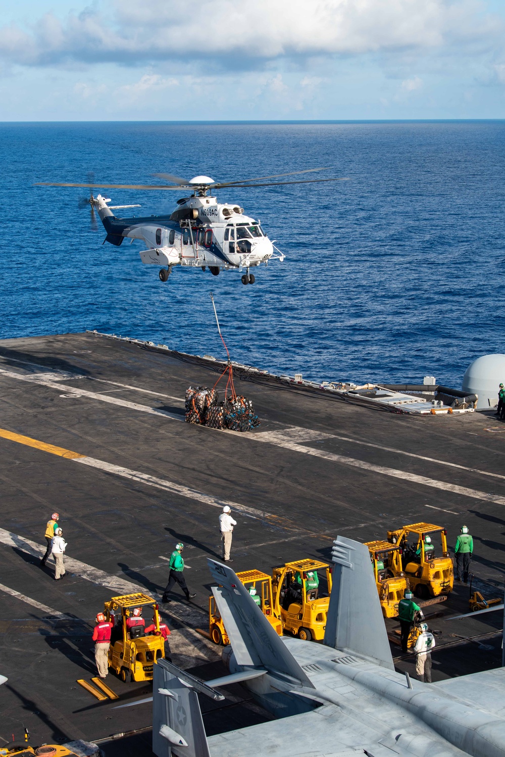 USS Ronald Reagan (CVN 76) conducts replenishment-at-sea with USNS Yukon (T-AO 202) and USNS Carl Brashear (T-AKE 7)