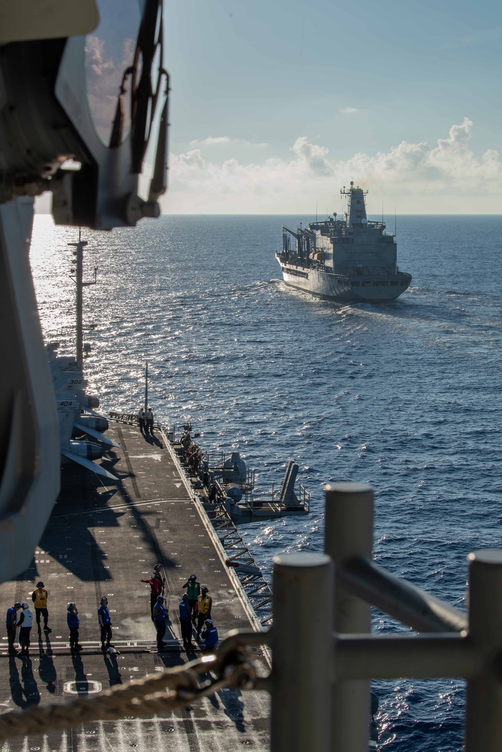 USS Ronald Reagan (CVN 76) conducts replenishment-at-sea with USNS Yukon (T-AO 202) and USNS Carl Brashear (T-AKE 7)