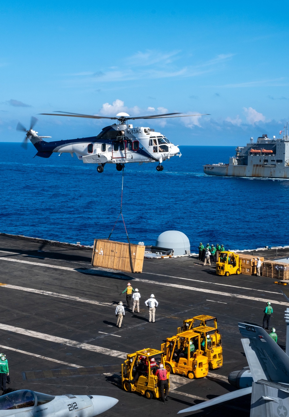 USS Ronald Reagan (CVN 76) conducts replenishment-at-sea with USNS Yukon (T-AO 202) and USNS Carl Brashear (T-AKE 7)