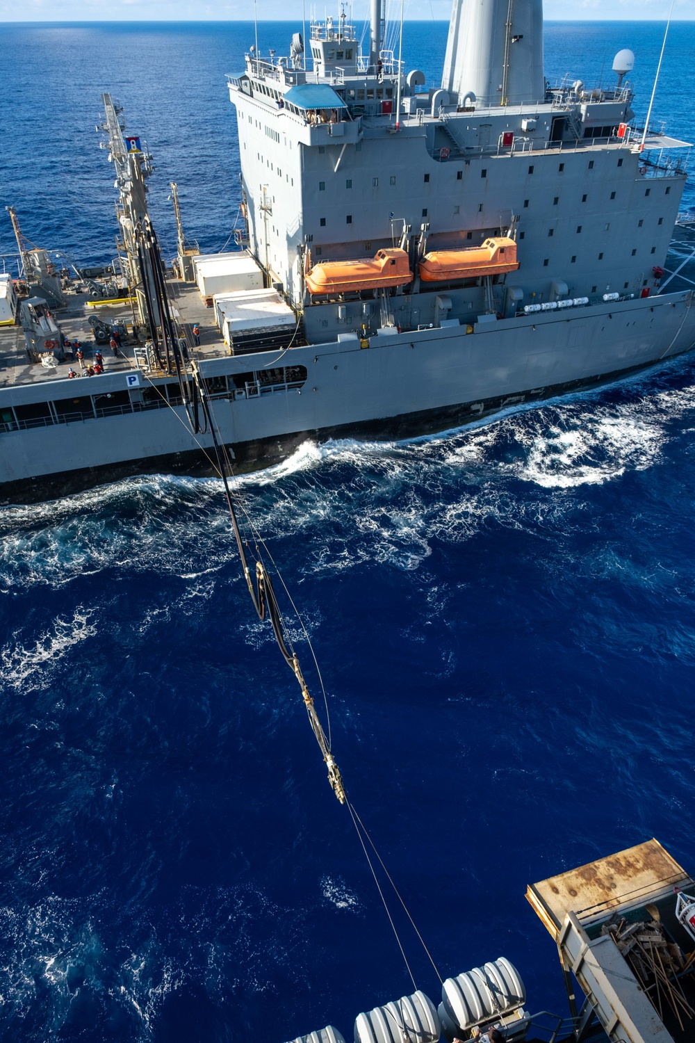 USS Ronald Reagan (CVN 76) conducts replenishment-at-sea with USNS Yukon (T-AO 202) and USNS Carl Brashear (T-AKE 7)