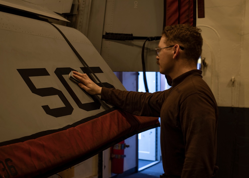 Sailor Cleans a Jet Aboard USS Carl Vinson (CVN 70)