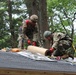 990th Engineer Vertical Construction Company Soldiers install shingles on the roof of the Devens Reserve Forces Training Facility range gas chamber in Devens, Mass., August 4, 2023.
