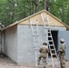 990th Engineer Vertical Construction Company Soldiers begin installing shingles onto the roof of the new concrete gas chamber on Devens Reserve Forces Training Facility range gas chamber in Devens, Mass., August 4, 2023.