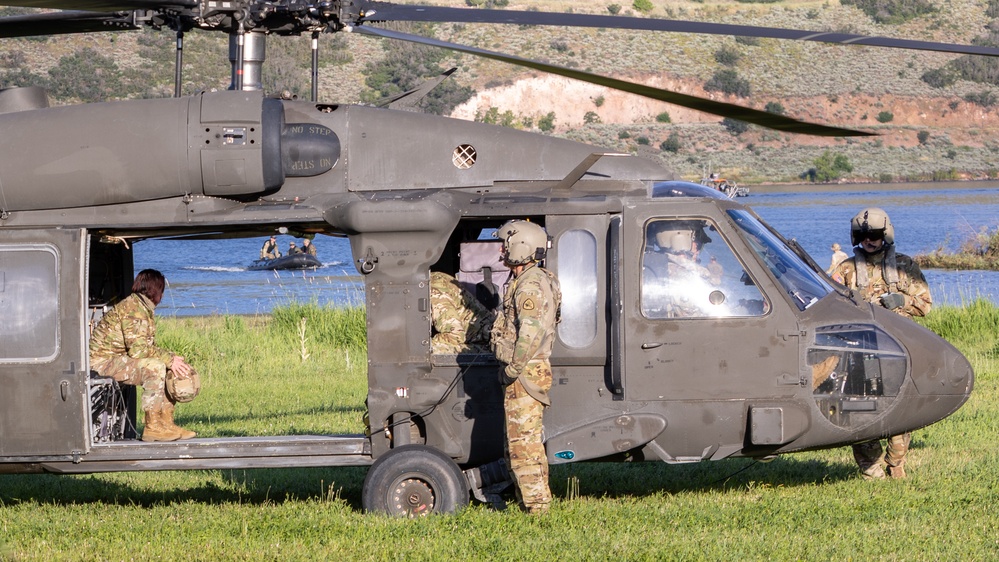 Soldiers with the 19th Special Forces Group (Airborne) parachute into Deer Creek Reservoir near Heber City, Utah