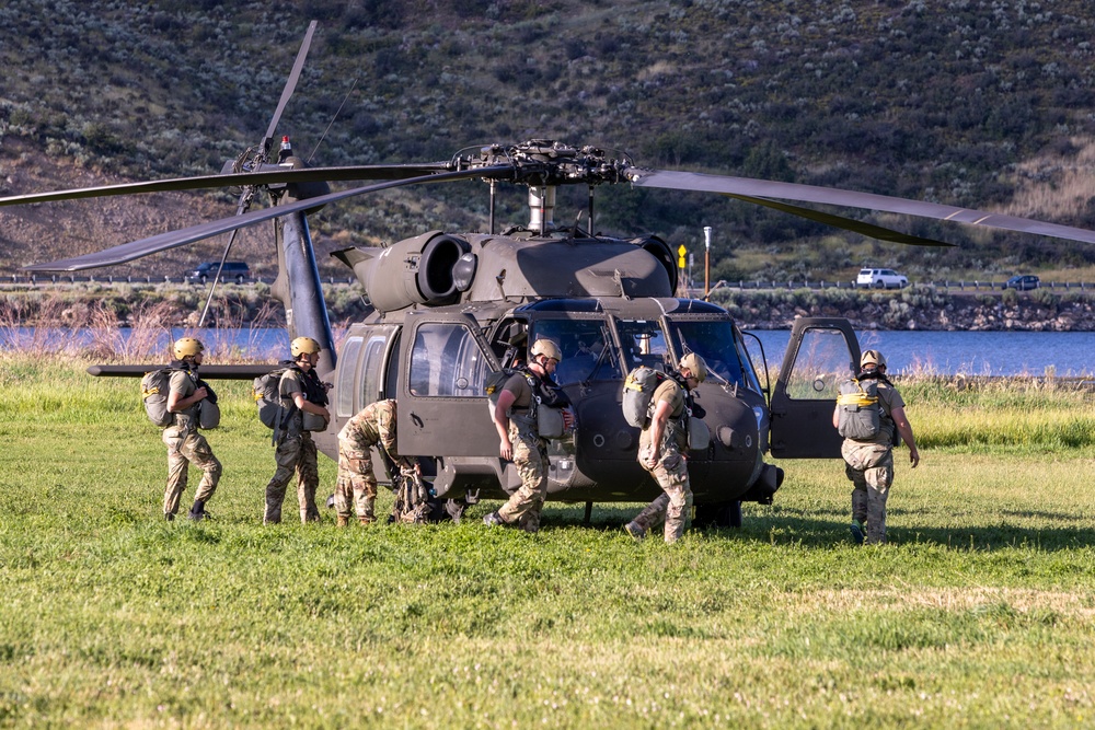 Soldiers with the 19th Special Forces Group (Airborne) parachute into Deer Creek Reservoir near Heber City, Utah