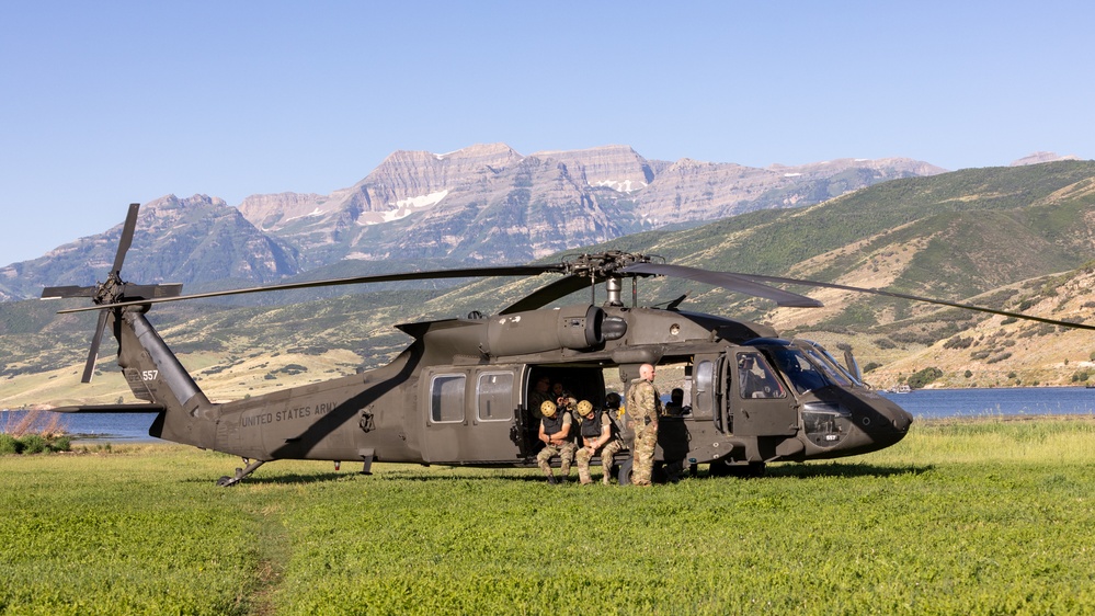 Soldiers with the 19th Special Forces Group (Airborne) parachute into Deer Creek Reservoir near Heber City, Utah