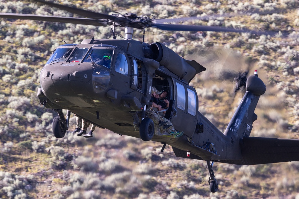 Soldiers with the 19th Special Forces Group (Airborne) parachute into Deer Creek Reservoir near Heber City, Utah