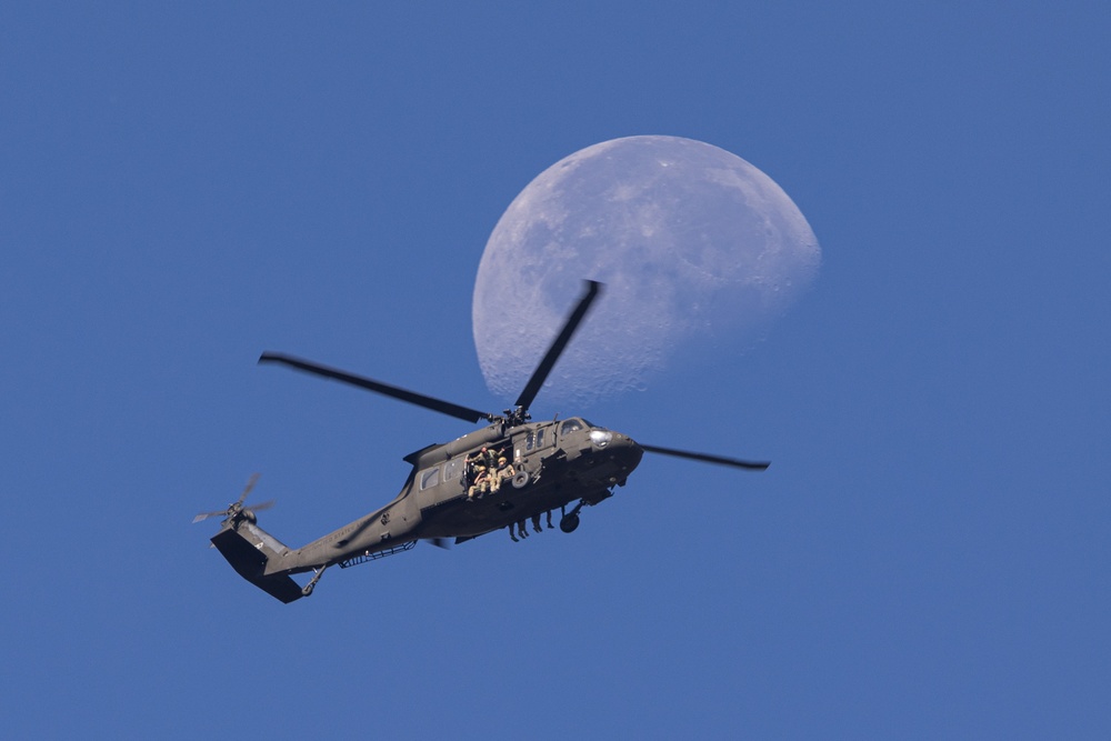 Soldiers with the 19th Special Forces Group (Airborne) parachute into Deer Creek Reservoir near Heber City, Utah