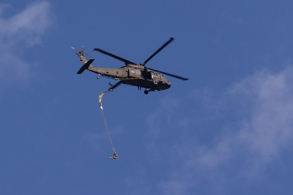 Soldiers with the 19th Special Forces Group (Airborne) parachute into Deer Creek Reservoir near Heber City, Utah