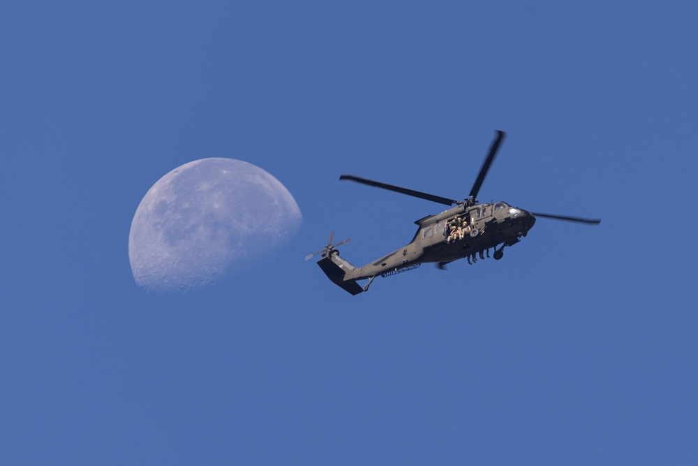 Soldiers with the 19th Special Forces Group (Airborne) parachute into Deer Creek Reservoir near Heber City, Utah