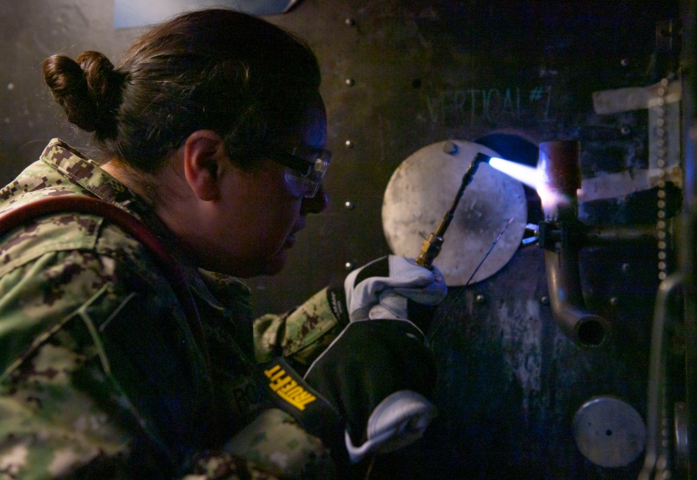 Sailor Training at TRFB Brazes a Pipe Coupling