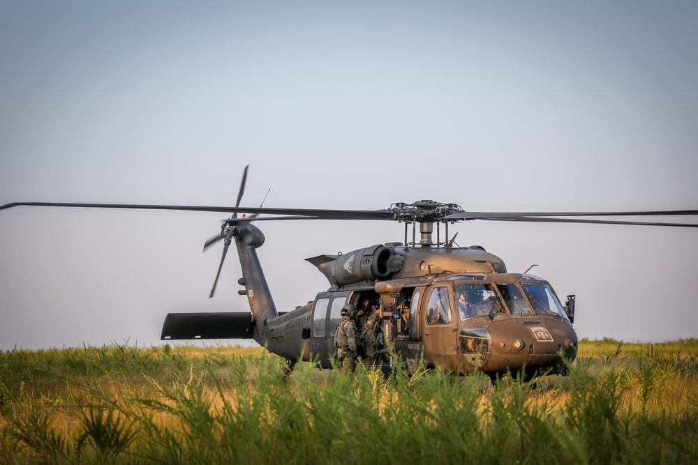 Paratroopers Conduct Load Up Onto Helicopter In Preparation For Air Assault