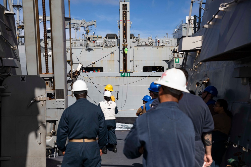 USS Ralph Johnson conducts a replenishment-at-sea with the USNS Matthew Perry.