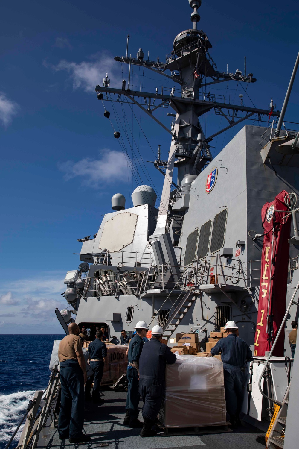 USS Ralph Johnson conducts a replenishment-at-sea with the USNS Matthew Perry.