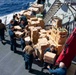 USS Ralph Johnson conducts a replenishment-at-sea with the USNS Matthew Perry.