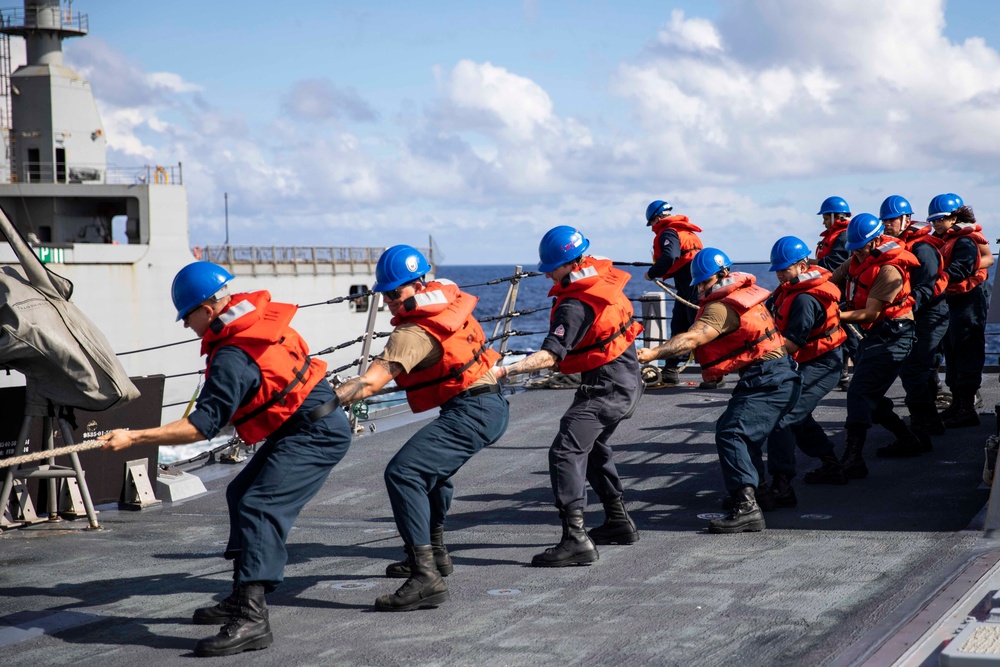 USS Ralph Johnson conducts a replenishment-at-sea with the USNS Matthew Perry.