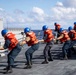 USS Ralph Johnson conducts a replenishment-at-sea with the USNS Matthew Perry.