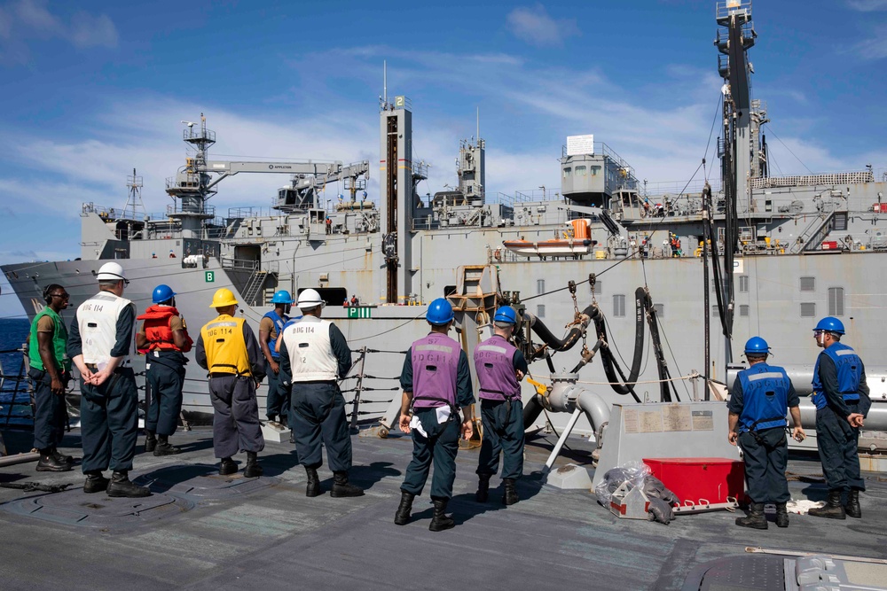 USS Ralph Johnson conducts a replenishment-at-sea with the USNS Matthew Perry.