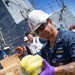 USS Ralph Johnson conducts a replenishment-at-sea with the USNS Matthew Perry.