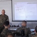 Division gunner briefs officers on weapons, equipment during company commander course