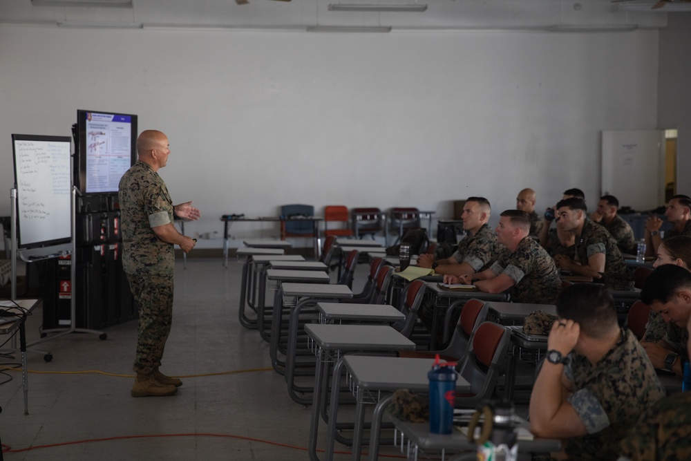 Division gunner briefs officers on weapons, equipment during company commander course