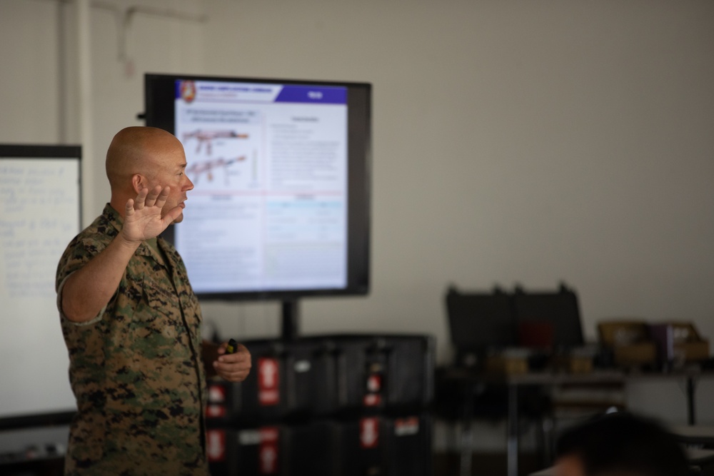 Division gunner briefs officers on weapons, equipment during company commander course