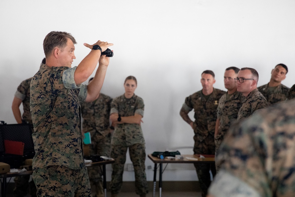 Division gunner briefs officers on weapons, equipment during company commander course