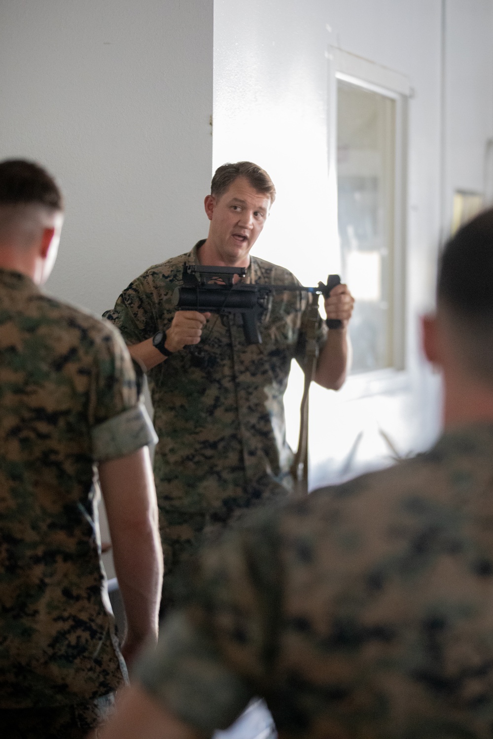 Division gunner briefs officers on weapons, equipment during company commander course