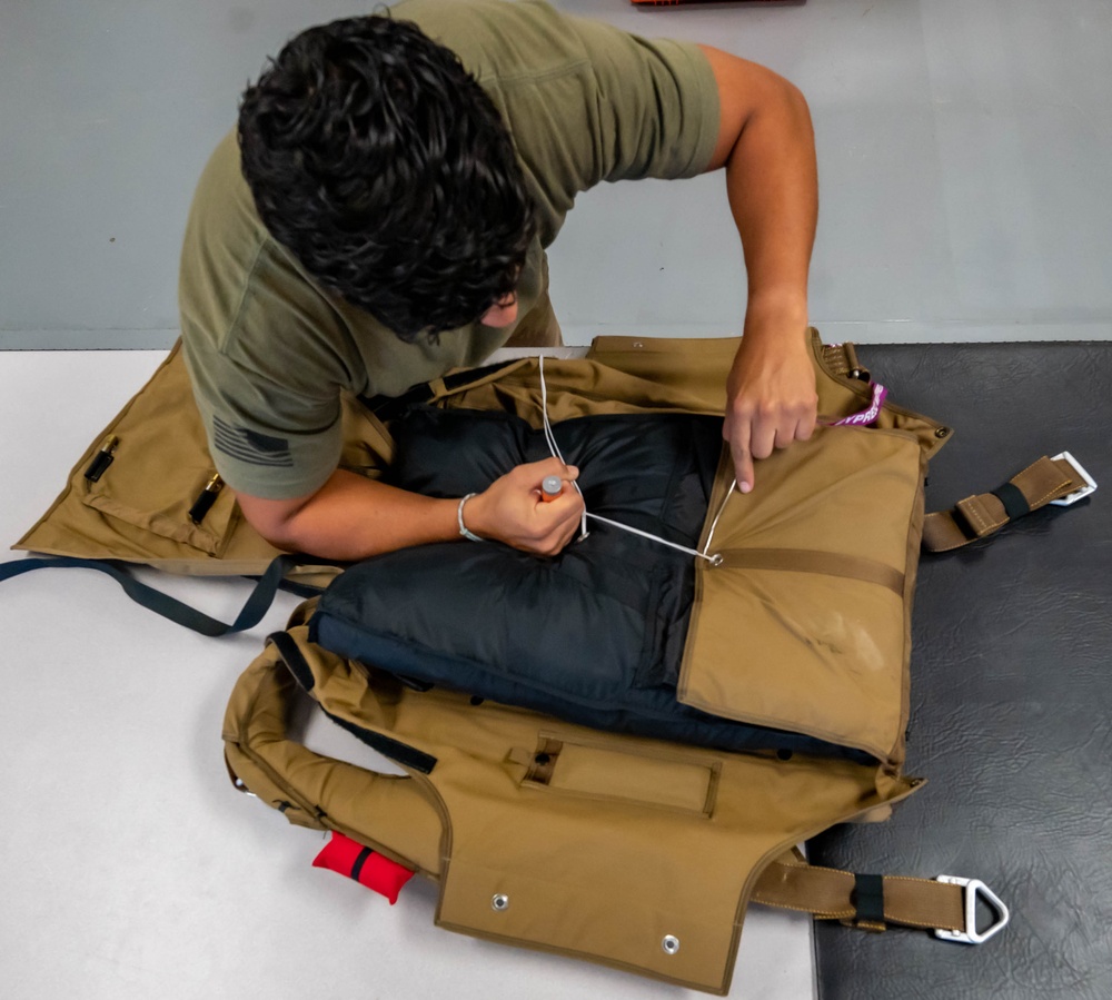 Aircrew flight equipment technician repacks a BA-30 Low Profile parachute