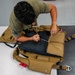 Aircrew flight equipment technician repacks a BA-30 Low Profile parachute