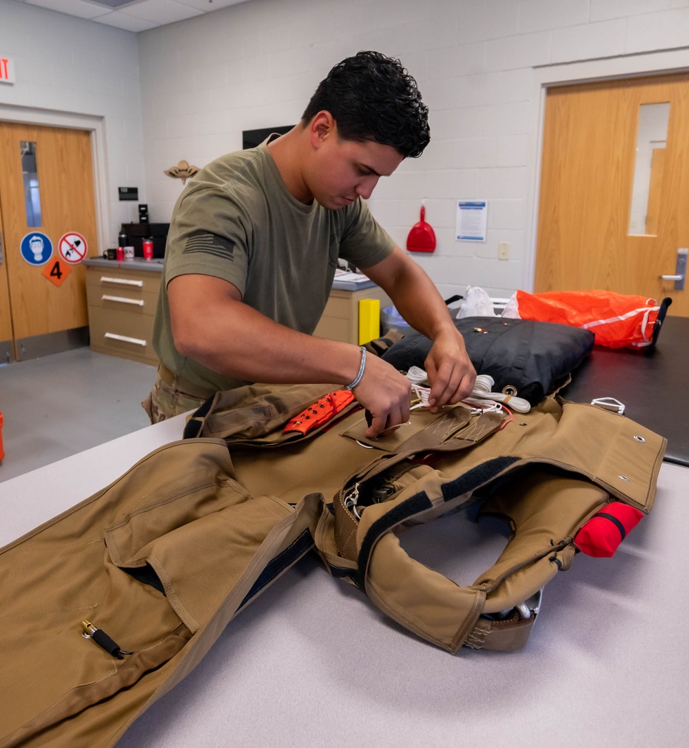 Aircrew flight equipment technician repacks a BA-30 Low Profile parachute