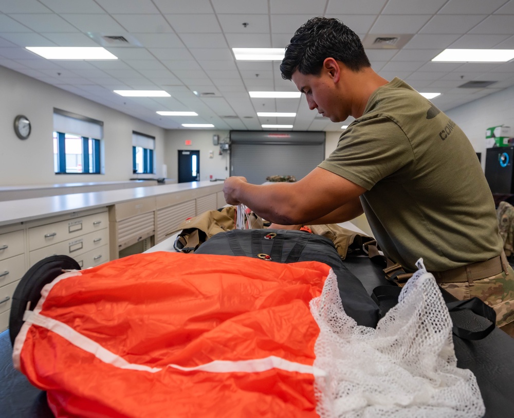 Aircrew flight equipment technician repacks a BA-30 Low Profile parachute