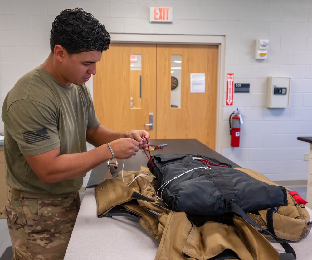 Aircrew flight equipment technician repacks a BA-30 Low Profile parachute