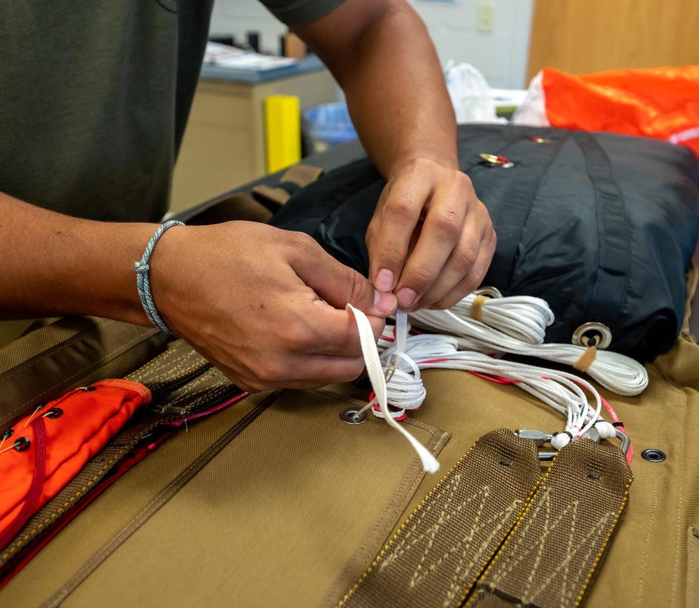 Aircrew flight equipment technician repacks a BA-30 Low Profile parachute