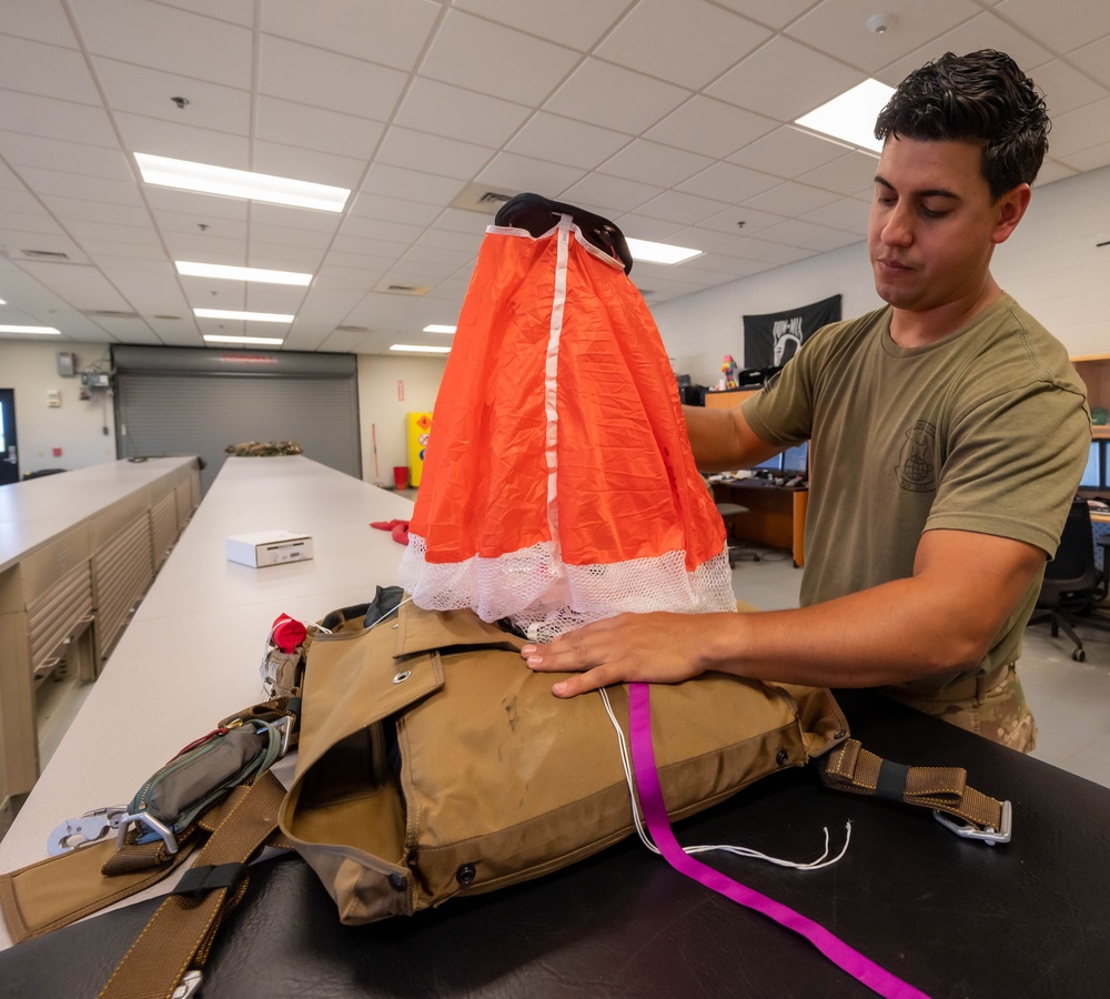 Aircrew flight equipment technician repacks a BA-30 Low Profile parachute