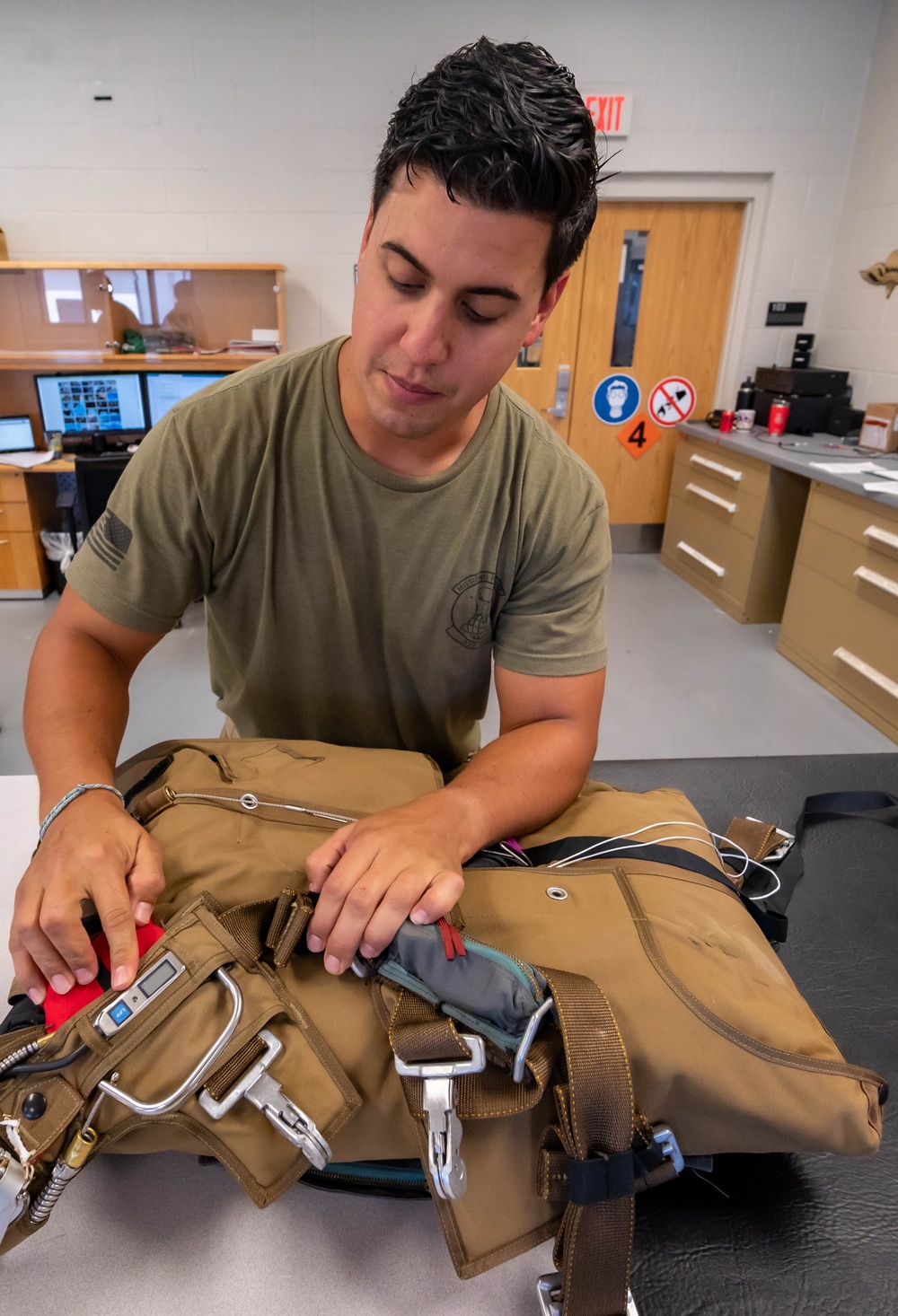 Aircrew flight equipment technician repacks a BA-30 Low Profile parachute