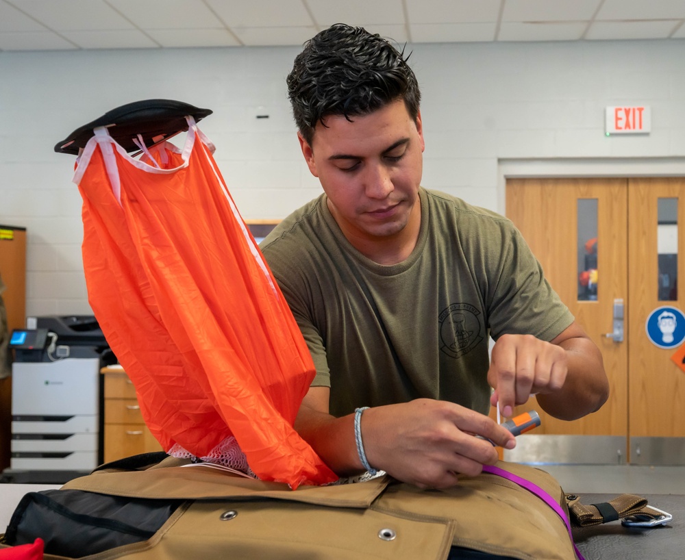 Aircrew flight equipment technician repacks a BA-30 Low Profile parachute